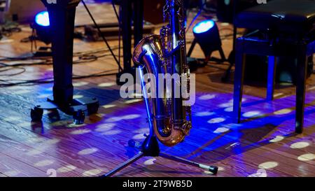 Saxophone on stage in blue light. Stock Photo