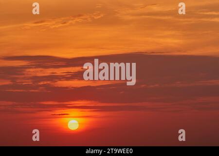 The sky was ablaze with vibrant oranges and pinks as the sun dipped below the horizon Stock Photo