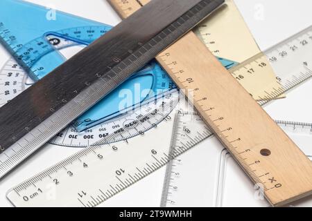 Various rulers of different shapes on white background Stock Photo