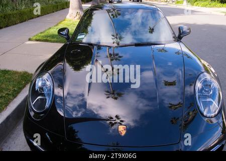 Palm trees reflecting on a Porsche. Beverly Hills, Los Angeles, California, United States of America Stock Photo