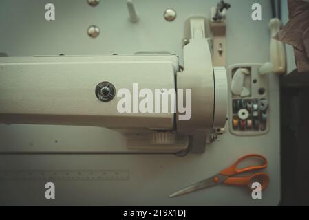 Sewing machine and threads on the table. Stock Photo