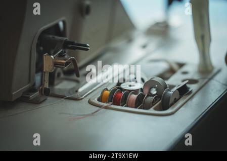Sewing machine and threads on the table. Stock Photo