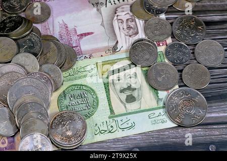 Saudi Arabia riyals money banknote bills and coins of different eras from the kingdom of Saudi Arabia times, vintage retro old Saudi currency, value, Stock Photo