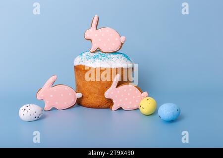 Three cute pink gingerbreads in the form of a rabbit on Easter cake Stock Photo