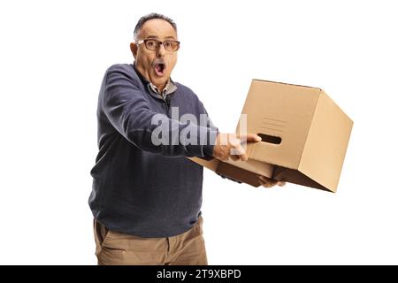 Shocked mature man holding an empty cardboard box upside down isolated on white background Stock Photo