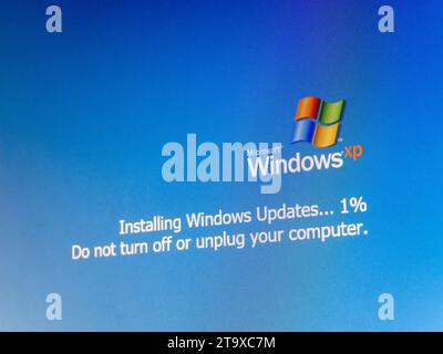 Microsoft Windows XP operating system update, installing updates one percent progress, do not turn off or unplug your computer OS update message simpl Stock Photo