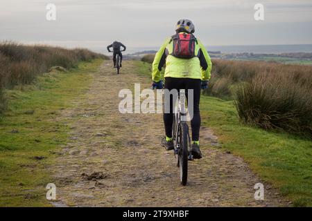 21.11.23 Darwen, Lancashire, UK. Man in black lycra mountain biking at Darwen Tower on the West pennine Moors in Lancashire Stock Photo