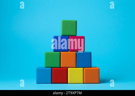 Pyramid of blank colorful cubes on light blue background Stock Photo