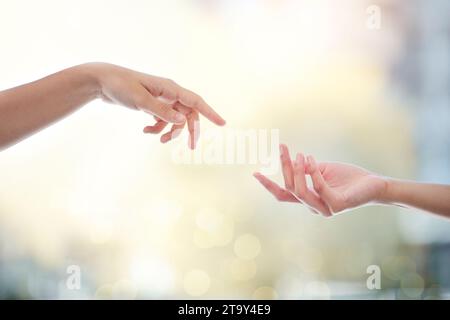 Helping hand, people and giving for support with bokeh, hope and empathy for healing or mental health. Hands, reaching and donation for charity Stock Photo