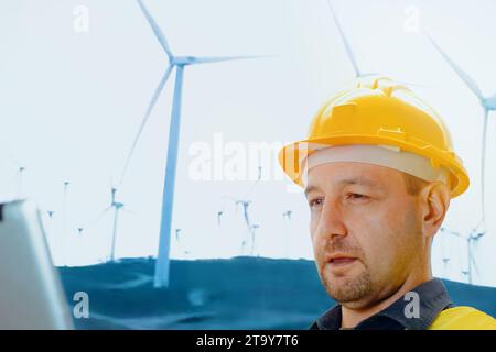 Wind turbine technician checking service. Engineer team professional working maintenance clean power generator system. Stock Photo