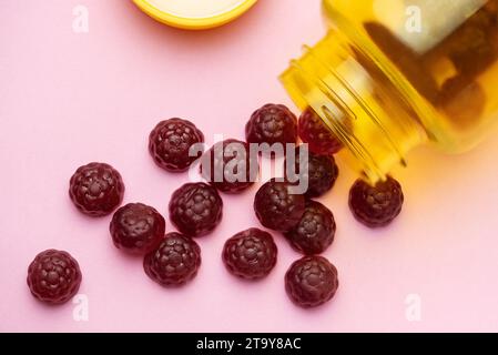 Vitamins for children,   jelly gummy fruits candy on pink  background Stock Photo