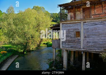 A derelict residential building on the River Una in Kulen Vakuf village in Una National Park. Una-Sana Canton, Federation of Bosnia and Herzegovina Stock Photo