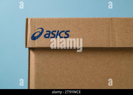 Antalya, Turkey - November 28, 2023: Sport shoe box with Asics logo printed. on blue background Stock Photo