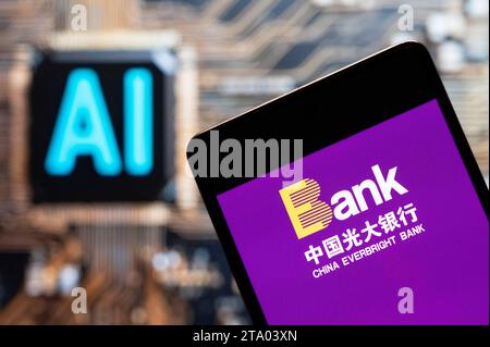 China. 3rd Nov, 2023. In this photo illustration, the Chinese state-owned banking and financial services enterprise China Everbright logo seen displayed on a smartphone with an Artificial intelligence (AI) chip and symbol in the background. (Credit Image: © Budrul Chukrut/SOPA Images via ZUMA Press Wire) EDITORIAL USAGE ONLY! Not for Commercial USAGE! Stock Photo