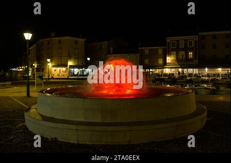 Cres, Croatia - April 8, 2023: Detail of a fountain on the main square near the harbor in Cres with colored lights Stock Photo