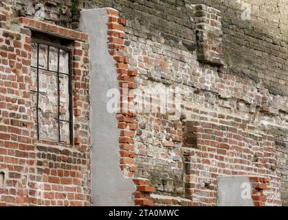 Duisburg, Germany. 28th Nov, 2023. View of part of the oldest surviving post-Roman city wall in Germany. Extensive sections of around one kilometer of Duisburg's medieval city wall have survived and have been restored in sections for almost 20 years now. Built between the 12th and 14th centuries, the defensive wall was hidden for years between industrial buildings in Duisburg harbor. Credit: Roland Weihrauch/dpa/Alamy Live News Stock Photo