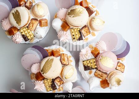 Beautiful traditional Orthodox Easter cakes decorated with glaze, meringues, chocolate, nuts, toffees, macaroons, flowers and jelly Stock Photo