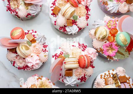 Beautiful traditional Orthodox Easter cakes decorated with glaze, meringues, chocolate, nuts, toffees, macaroons, flowers and jelly Stock Photo