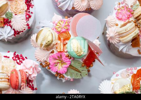 Beautiful traditional Orthodox Easter cakes decorated with glaze, meringues, chocolate, nuts, toffees, macaroons, flowers and jelly Stock Photo