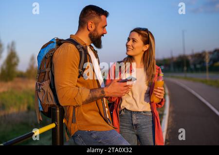 Happy smiling couple using smartphone in the city. Stock Photo
