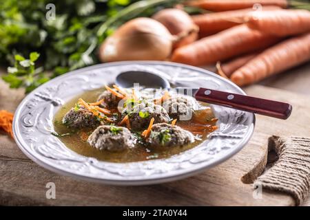 Broth with liver dumplings made from beef liver, bread, eggs and parsley cooked in beef broth. Leberknödelsuppe – German Liver Dumpling Soup. Stock Photo