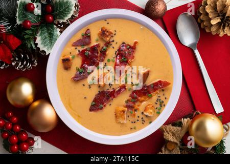 Salmorejo, cold tomato soup with ham. Traditional Spanish tapa served on a table with Christmas decorations. Stock Photo