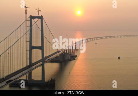 (231128) -- ZHONGSHAN, Nov. 28, 2023 (Xinhua) -- This aerial photo taken on Nov. 27, 2023 shows the Lingdingyang bridge of the Shenzhen-Zhongshan link in south China's Guangdong Province. A cross-sea highway project between the cities of Shenzhen and Zhongshan in south China's Guangdong Province is one step closer to completion.   The last pouring of concrete was put in place on Tuesday, as work on the immersed tube underwater tunnel, which spans around 6.8 km, is nearing its end, said Guangdong Provincial Communication Group Co., Ltd.    The tunnel is part of a 24-km-long highway connecting S Stock Photo
