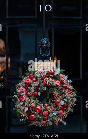 Downing Street, London, UK. 28th November 2023.  Festive wreath adorns the famous black door of No 10 Downing Street. Photo by Amanda Rose/Alamy Live News Stock Photo