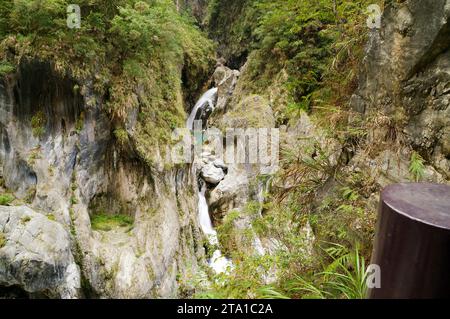 Tiny waterfall running between rocks Stock Photo