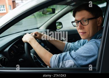 Male driver is sitting in the car. Stock Photo