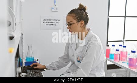 Young beautiful hispanic woman scientist smiling confident mixing ...