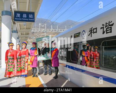 (231128) -- MAOXIAN, Nov. 28, 2023 (Xinhua) -- People pose for photos during the celebration for the operation of a section of the Sichuan-Qinghai railway at Maoxian railway station in Maoxian County, southwest China's Sichuan Province, Nov. 28, 2023. A 238-km section of the Sichuan-Qinghai railway in western China became operational on Tuesday after 12 years of construction.   The railway crosses the rugged, earthquake-prone plateau region in northwest Sichuan, and takes a detour to avoid disturbing the Giant Panda National Park.      The Sichuan-Qinghai railway will eventually stretch northw Stock Photo