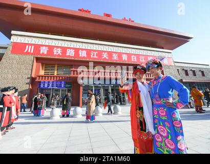 (231128) -- MAOXIAN, Nov. 28, 2023 (Xinhua) -- People pose for photos during the celebration for the operation of a section of the Sichuan-Qinghai railway at Maoxian railway station in Maoxian County, southwest China's Sichuan Province, Nov. 28, 2023. A 238-km section of the Sichuan-Qinghai railway in western China became operational on Tuesday after 12 years of construction.   The railway crosses the rugged, earthquake-prone plateau region in northwest Sichuan, and takes a detour to avoid disturbing the Giant Panda National Park.      The Sichuan-Qinghai railway will eventually stretch northw Stock Photo