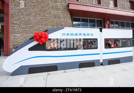 (231128) -- MAOXIAN, Nov. 28, 2023 (Xinhua) -- People pose for photos during the celebration for the operation of a section of the Sichuan-Qinghai railway at Maoxian railway station in Maoxian County, southwest China's Sichuan Province, Nov. 28, 2023. A 238-km section of the Sichuan-Qinghai railway in western China became operational on Tuesday after 12 years of construction.   The railway crosses the rugged, earthquake-prone plateau region in northwest Sichuan, and takes a detour to avoid disturbing the Giant Panda National Park.      The Sichuan-Qinghai railway will eventually stretch northw Stock Photo