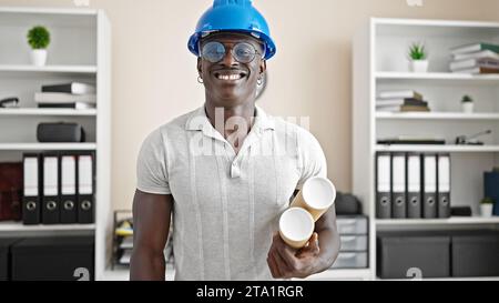 African american man architect smiling confident holding blueprints at the office Stock Photo