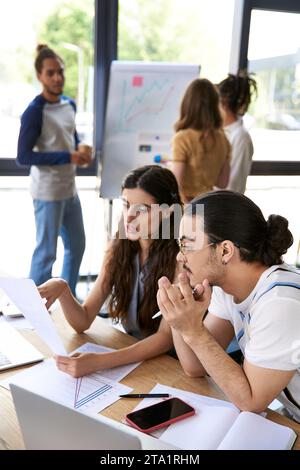 creative managers working with documents near devices and multiethnic team in modern office Stock Photo