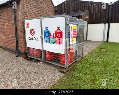 Calor Gas bottles in a storage cage at an inland waterways marina. Stock Photo