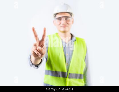 Young engineer counting number two isolated. Male engineer showing number two isolated Stock Photo