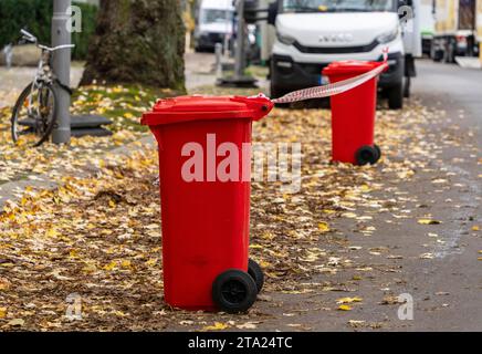 Barrier, red rubbish bins with red and white barrier tape, Berlin, Germany Stock Photo