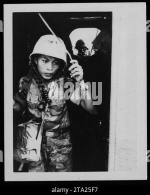 A group of ARVN (Army of the Republic of Vietnam) soldiers, including Vietnamese marines, gather in 1962 during the Vietnam War. The soldiers are dressed in camouflage uniforms and can be seen carrying various military equipment such as rifles and backpacks. Stock Photo