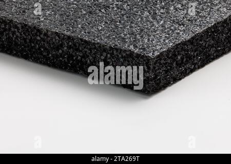 Black high-impact closed-cell polyethylene black foam sheet on white background. Specifically designed packing material. Stock Photo