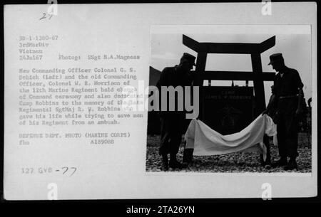 Change of Command ceremony and dedication of Camp Robbins to the memory of late Regimental SgtMaj R.W. Robbins. New Commanding Officer Colonel G.S. Schick (Left) takes over from the old Commanding Officer Colonel W.R. Morrison of the 12th Marine Regiment. Photograph taken on July 24, 1967 in Vietnam. Stock Photo