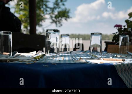 Table in a restaurant placed on the riverbank Stock Photo