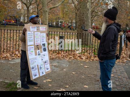 An evangelical Christian at Speaker's Corner in Hyde Park, London, is filmed as he talks by a man with a beard. Stock Photo