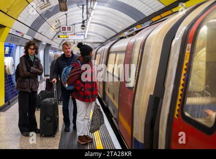 Passengers wait to board an arriving London Underground, or Tube, train at Bond Street station on the Jubilee Line, London, UK Stock Photo