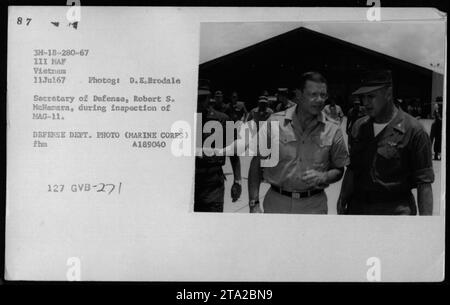 Prominent government officials, including Vice President Hubert Humphrey, General William Westmoreland, and Senator Harry F. Byrd, visited Vietnam on July 11, 1967. During their trip, they met with Secretary of Defense Robert S. McNamara and inspected Marine Aircraft Group 11. This photograph captures McNamara during the inspection. Stock Photo