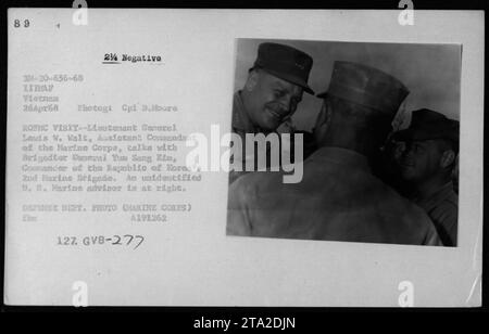 Lt Gen Lewis W Walt, Assistant Commandant of the Marine Corps, is seen talking with Brigadier General Yum Sang Kim, Commander of the Republic of Korea's 2nd Marine Brigade in Vietnam. There is also an unidentified U.S. Marine advisor present in the image. This photograph was taken on April 26, 1968. Stock Photo