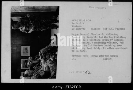 Major General Charles F. Widdecke, Commanding General, 1st Marine Division, listens to a briefing given by Colonel E. G. Derning, Commanding Officer, 7th Marines, in 7th Marines briefing room at Landing Zone Baldy, 21 miles southwest of Da Nang. The photo was taken on May 20, 1970, by Cpl. R.L. Pearson. Stock Photo