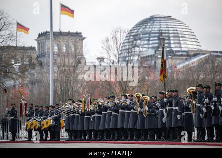 Berlin, Germany. 28th Nov, 2023. Soldiers of the guard battalion and military band stand at the Chancellery to welcome the Prime Minister of Malta. The Reichstag can be seen in the background. Malta is one of Germany's most important economic and trading partners. Credit: Hannes P Albert/dpa/Alamy Live News Stock Photo