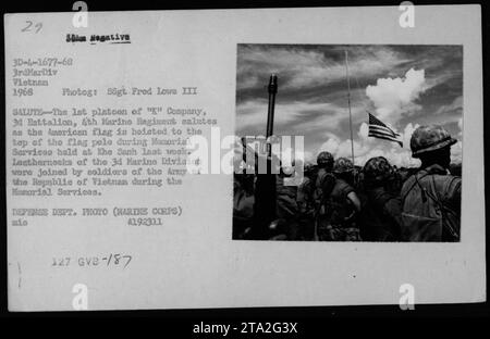 Image: The image shows a group of soldiers, both American and soldiers from the Army of the Republic of Vietnam, saluting as the American flag is being raised during Memorial Services at Khe Sanh. This photograph was taken in 1968 by SSgt Fred Love III, a photographer for the Defense Department. Stock Photo